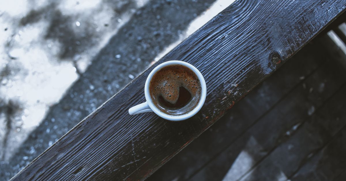 A cup of black coffee on a wooden table