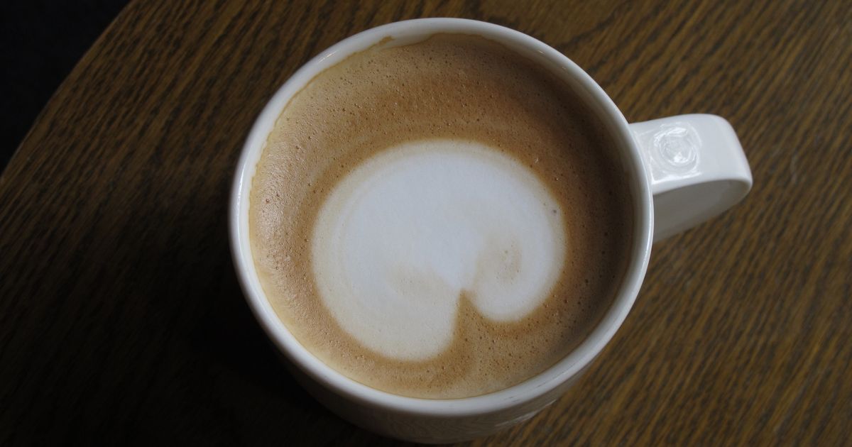 A frothy cappuccino in a cup on a wooden table