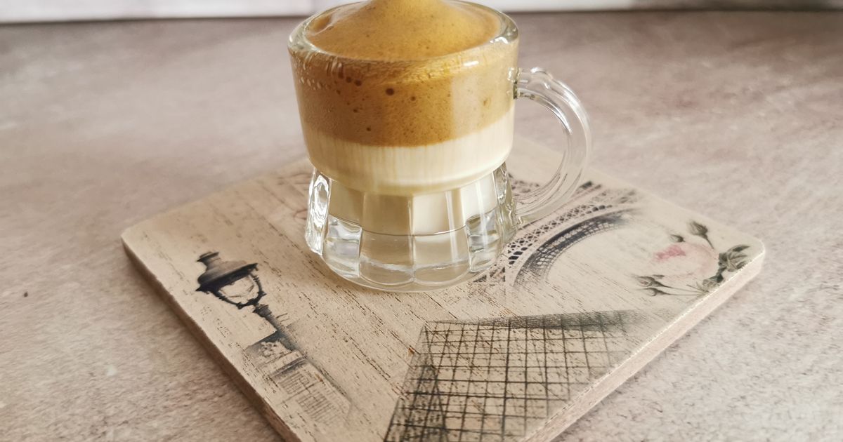 Dalgona coffee with whipped coffee foam in a glass mug